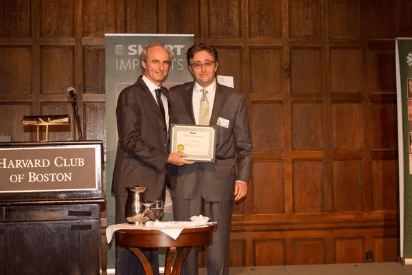 Dr. Morgan, owner of Bicon, presenting a certificate of achievement to Dr. Alex Osinovsky at the Harvard Club of Boston